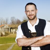 portrait-smiling-man-standing-against-sky